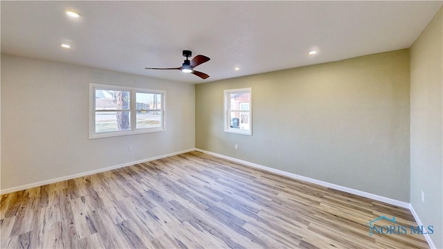 unfurnished room with ceiling fan and light hardwood / wood-style floors