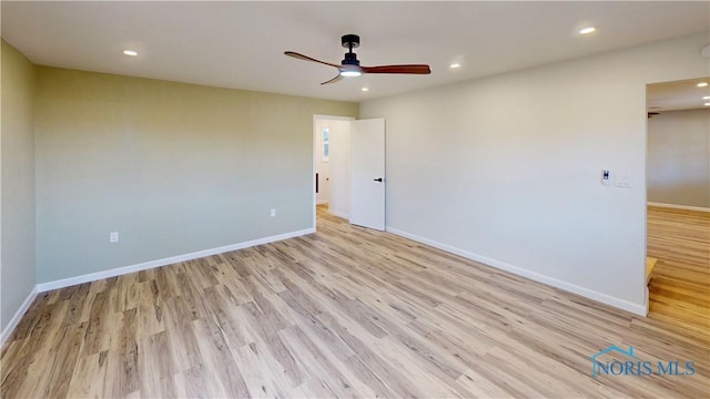 spare room featuring light hardwood / wood-style floors and ceiling fan