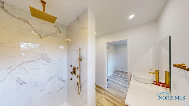 bathroom with sink, hardwood / wood-style floors, and walk in shower