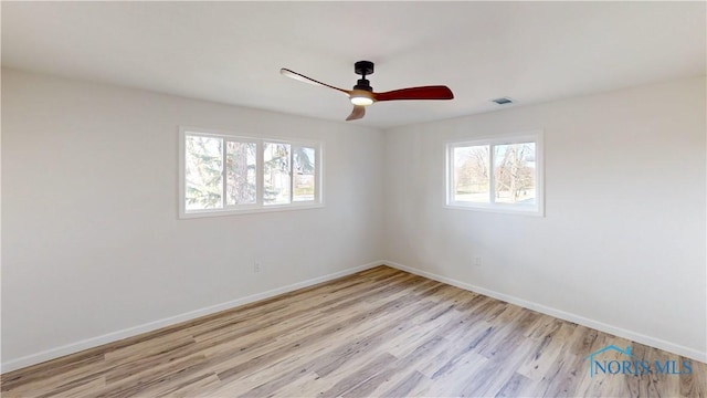 spare room with ceiling fan and light hardwood / wood-style flooring