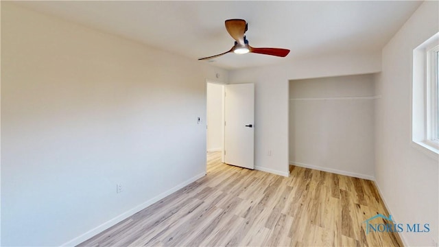 unfurnished bedroom featuring a closet, ceiling fan, and light hardwood / wood-style flooring