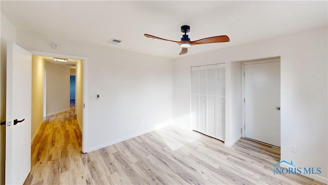 unfurnished bedroom with ceiling fan and light hardwood / wood-style floors