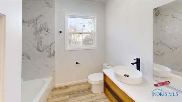 bathroom with vanity, hardwood / wood-style floors, and toilet