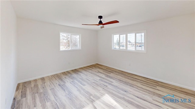 empty room with ceiling fan and light wood-type flooring