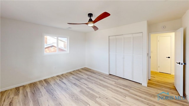 unfurnished bedroom featuring ceiling fan, a closet, and light hardwood / wood-style flooring