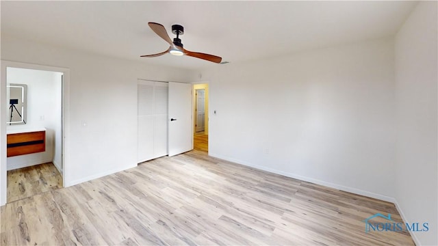 unfurnished bedroom with light hardwood / wood-style flooring, a closet, and ceiling fan