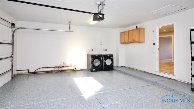 garage with a garage door opener and washer and clothes dryer