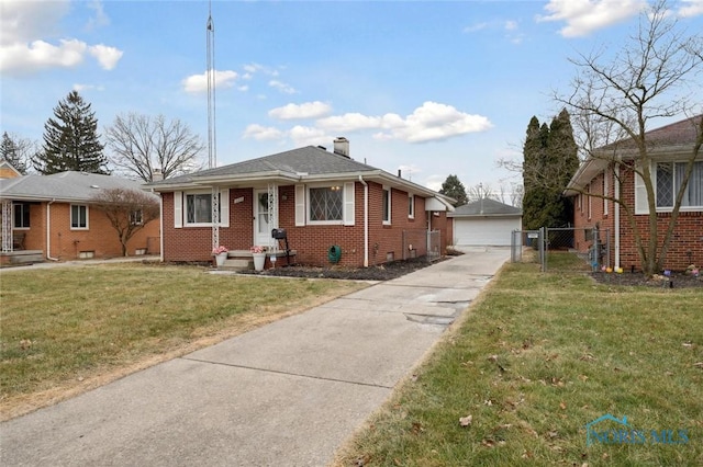 bungalow-style house featuring an outbuilding, a garage, and a front lawn