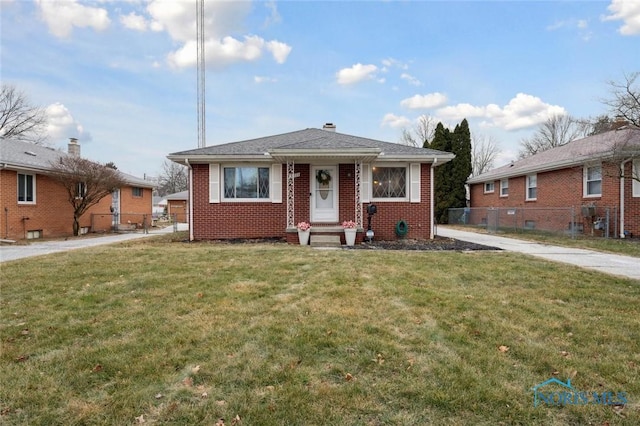 bungalow-style home with a front lawn