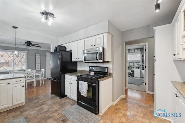 kitchen with backsplash, white cabinets, hanging light fixtures, and black appliances