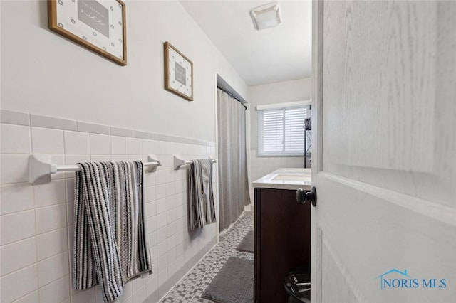 bathroom with vanity, tile patterned flooring, and tile walls