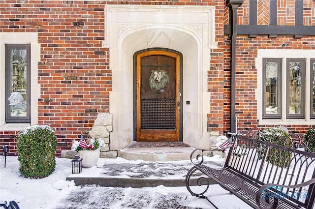 view of snow covered property entrance