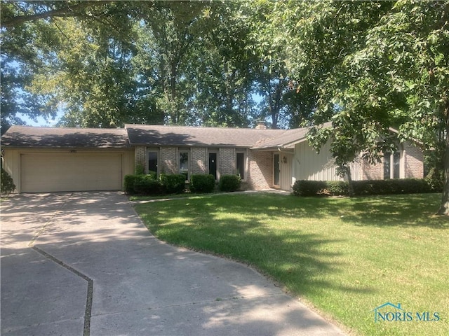 ranch-style home with a garage and a front yard