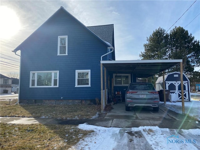 view of property exterior with a carport and a storage shed