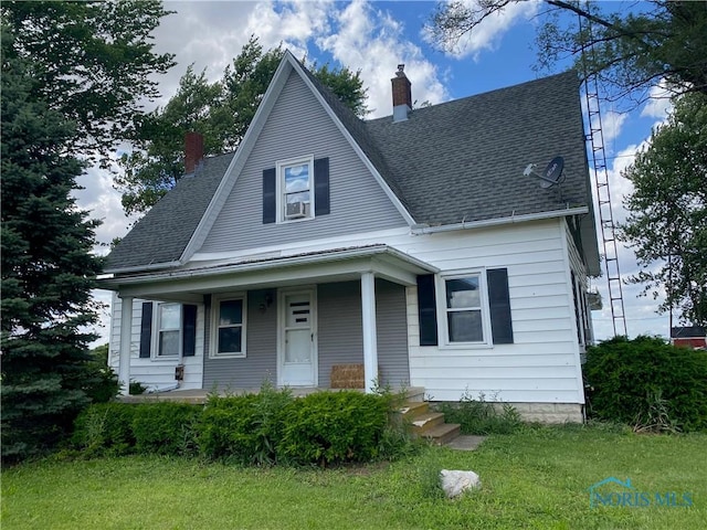 view of front of property with a front yard and covered porch