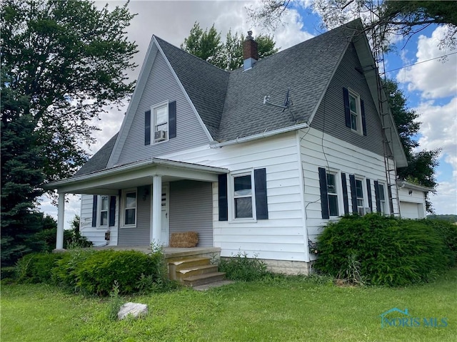 view of front of house with covered porch and a front yard