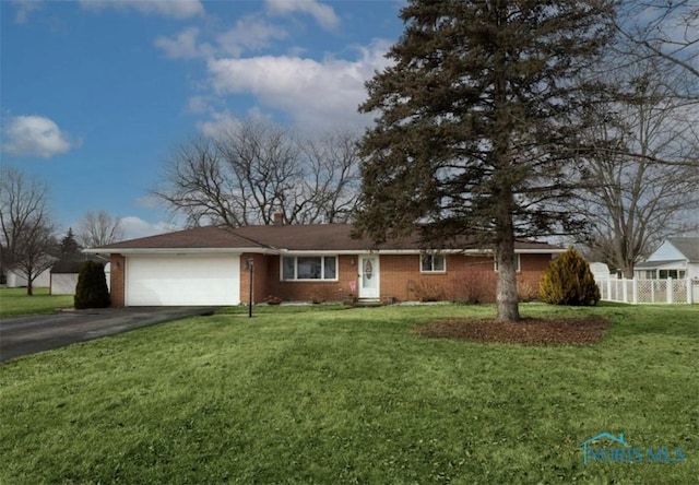 ranch-style home with a garage and a front lawn