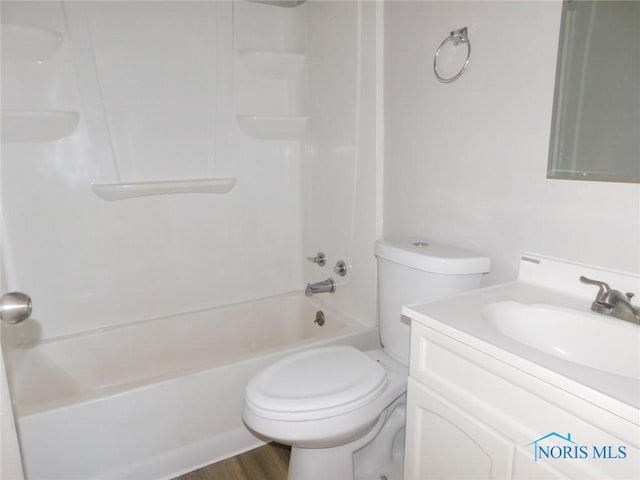 full bathroom with vanity, toilet,  shower combination, and wood-type flooring