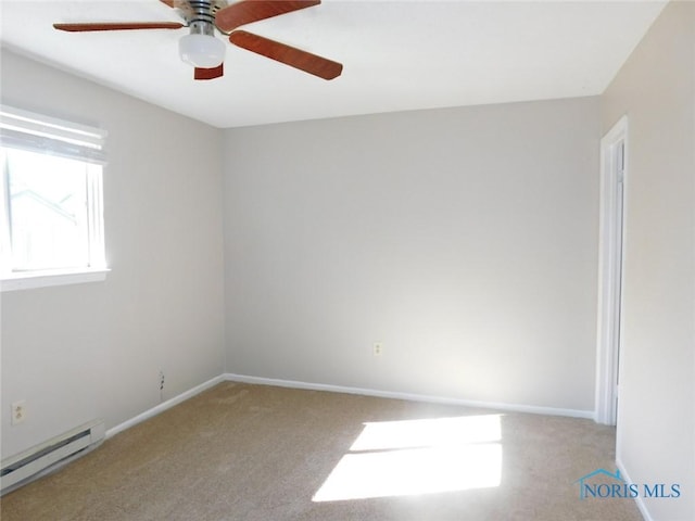 carpeted empty room featuring ceiling fan and baseboard heating