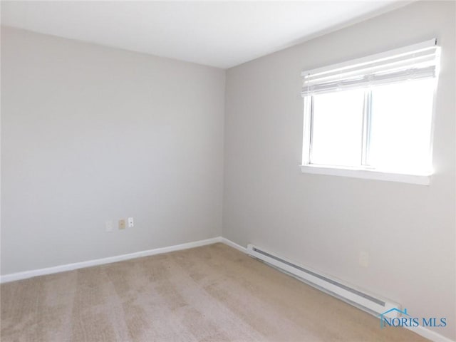 carpeted empty room featuring a baseboard radiator