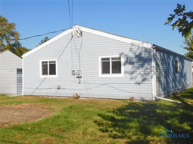 view of side of property with a lawn