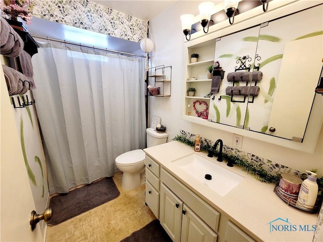 bathroom with walk in shower, vanity, and toilet