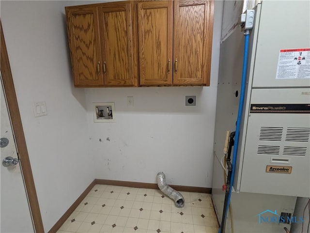 laundry area featuring cabinets, hookup for a washing machine, heating unit, and electric dryer hookup