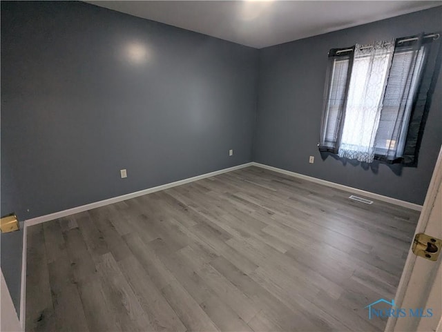 empty room with wood-type flooring