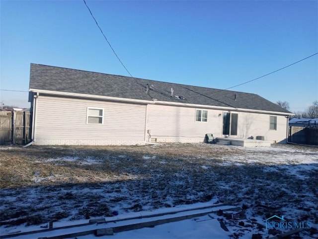 view of snow covered rear of property