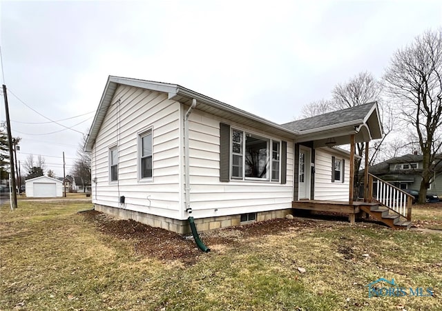 view of front of home with a garage and a front lawn