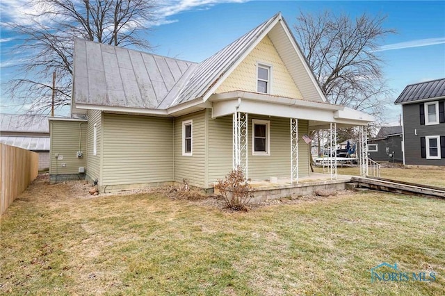 back of house with a lawn