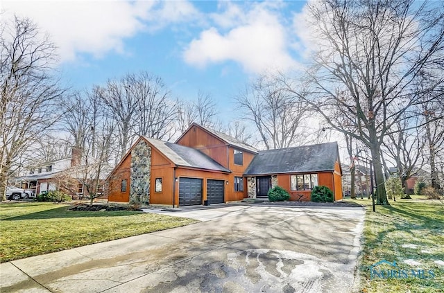 view of front facade with a garage and a front lawn