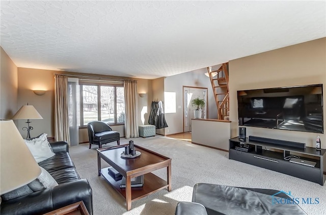 living room with light colored carpet and a textured ceiling