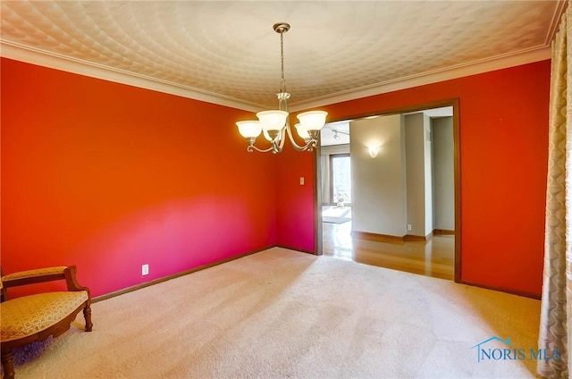 carpeted spare room with an inviting chandelier and crown molding