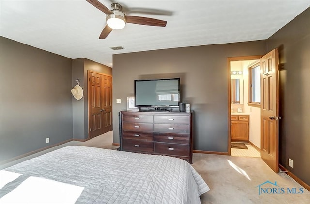 carpeted bedroom with ceiling fan, connected bathroom, and a closet