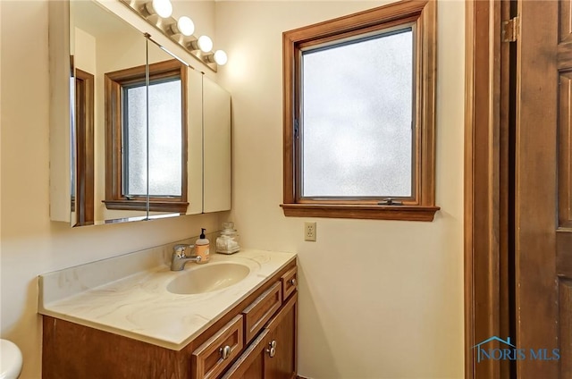 bathroom with vanity and toilet