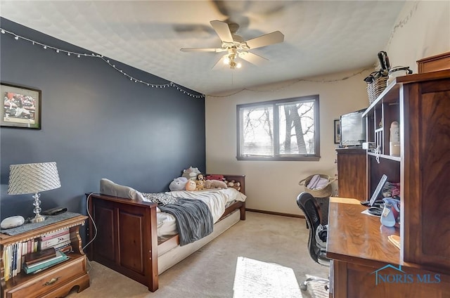 bedroom featuring light colored carpet and ceiling fan