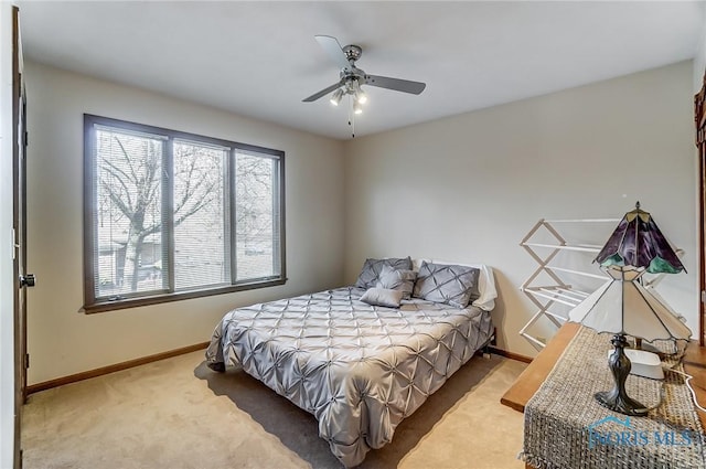 bedroom featuring ceiling fan, carpet floors, and multiple windows