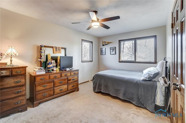 bedroom with light colored carpet and ceiling fan