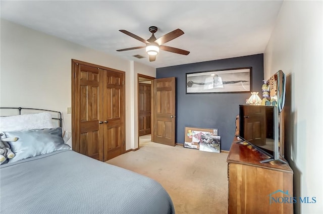 carpeted bedroom with ceiling fan