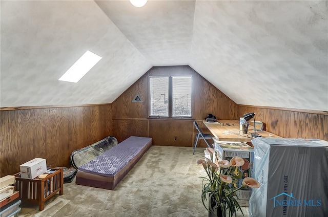 bedroom featuring lofted ceiling, light carpet, and wooden walls