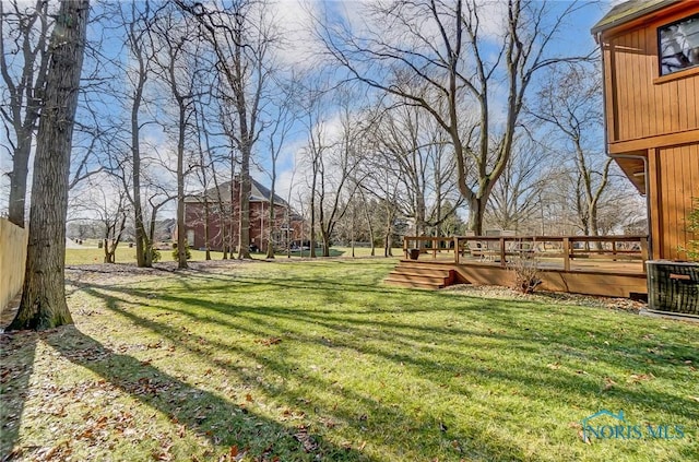 view of yard featuring a wooden deck and cooling unit