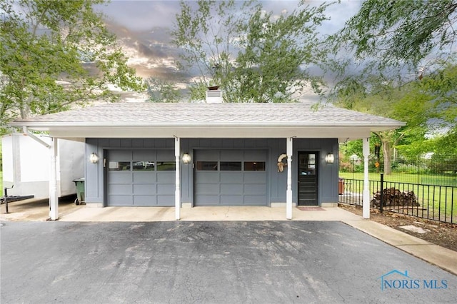 view of garage at dusk