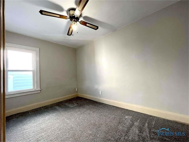 carpeted spare room featuring ceiling fan