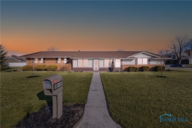 ranch-style house with a lawn