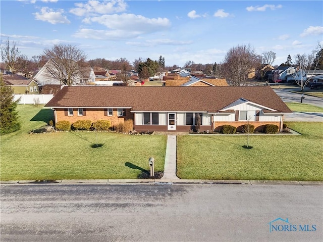 ranch-style home with a front yard