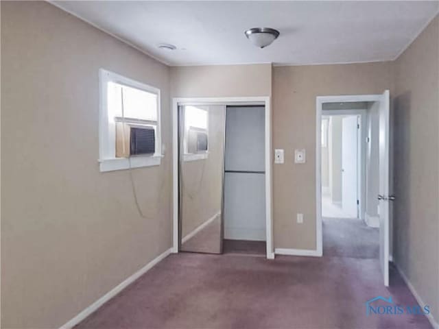 unfurnished bedroom with carpet floors and a closet