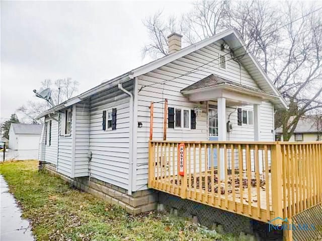 back of house with a wooden deck