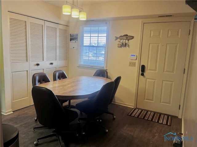 dining space featuring dark wood-type flooring