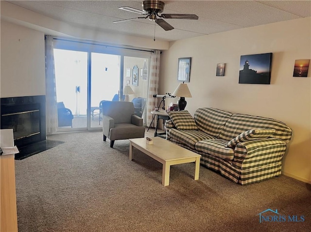 carpeted living room with ceiling fan